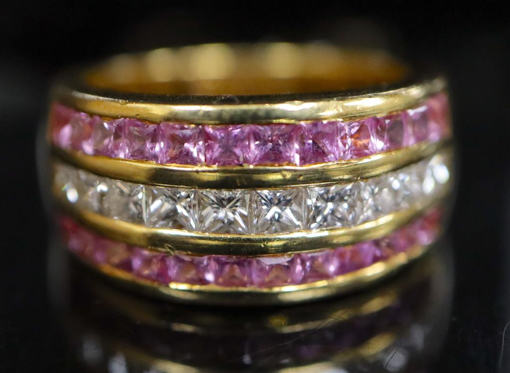 A modern 18ct gold, diamond and pink sapphire set three row dress ring,